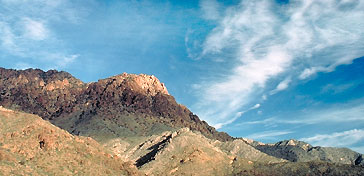 Mountains, sky, and thin clouds.
