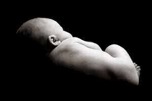 Infant on black background.
