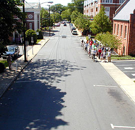 Participants walking and talking next to street.