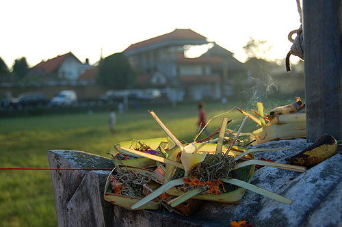 Rice offering or shrine with soccer field in background.