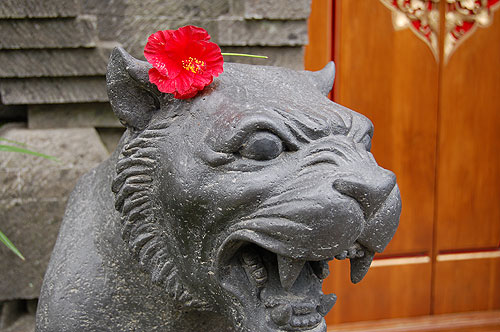Stone panther with flower.