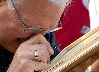 A closer look: a man investigates a frame for auction.