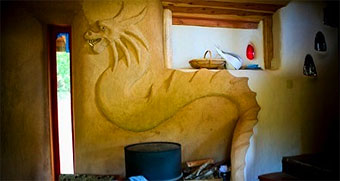 Cobb dragon sculpted into the wall of a cobb home at the Emerald Earth community.