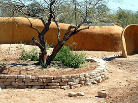 Stone Curves Cohousing exterior wall adjacent to community garden.