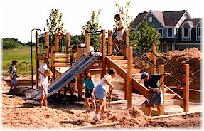 Neighbors working on playground structure.
